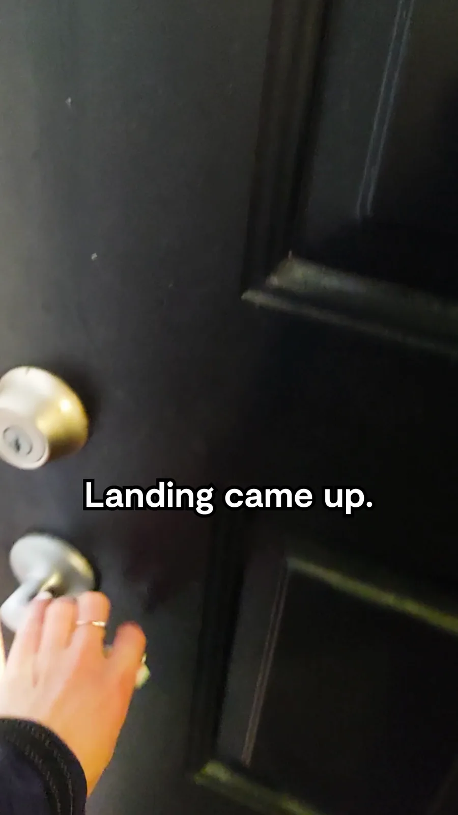 A tall video still, a moment later: a hand turns the knob of a dark apartment door, a caption saying the brand came up.