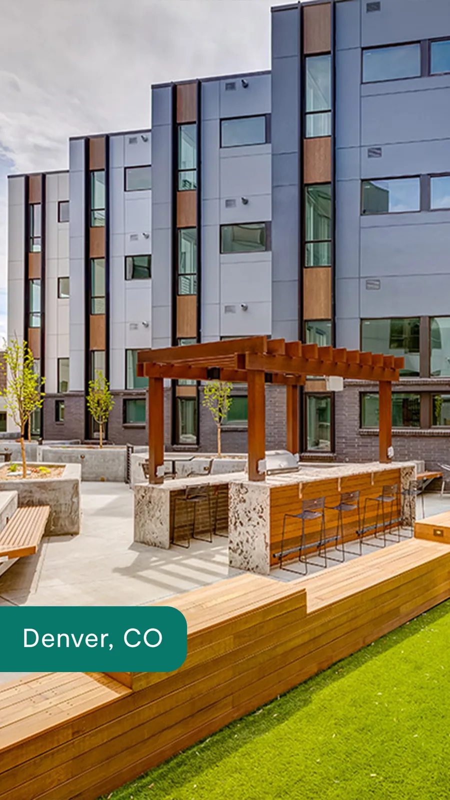 A tall ad: a new apartment building with a wood pergola and outdoor kitchen on a lawn courtyard, the city's name on a green tab at the bottom.